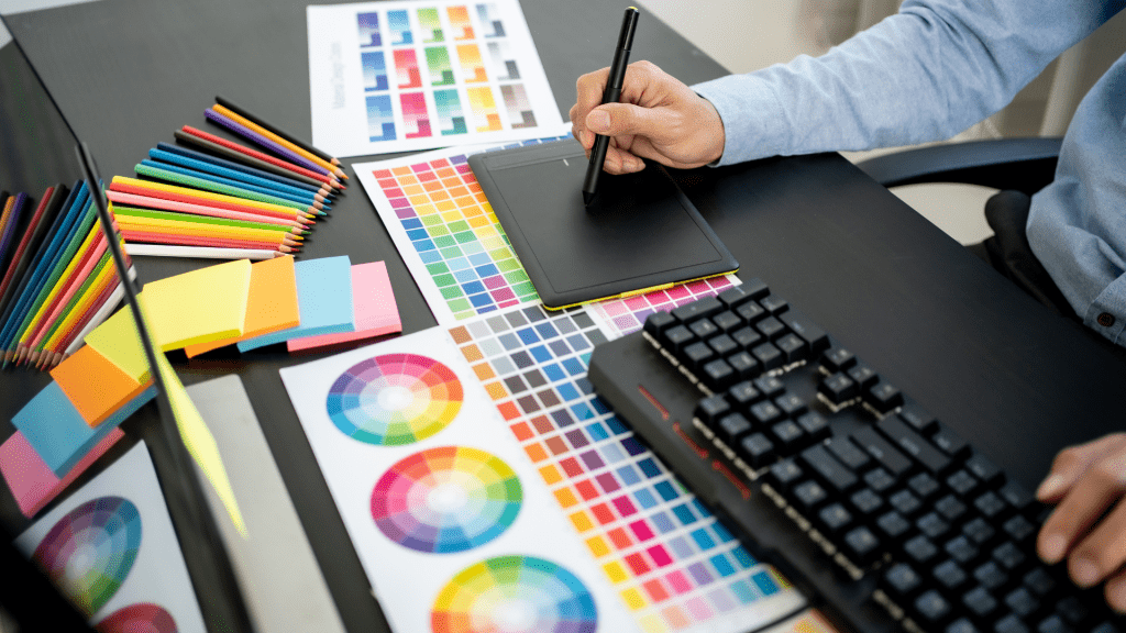 A digital artist using a drawing tablet with color swatches and design tools, representing digital design’s role in "Art vs. Design in Creative Industry